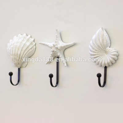 bedroom furniture or door behind seashell coat hook / wall hook